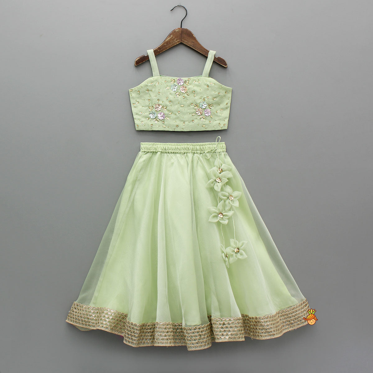 Floral Embroidered Green Sleeveless Top And Fabric Flower Tassels Adorned Lehenga With Ruffle Dupatta