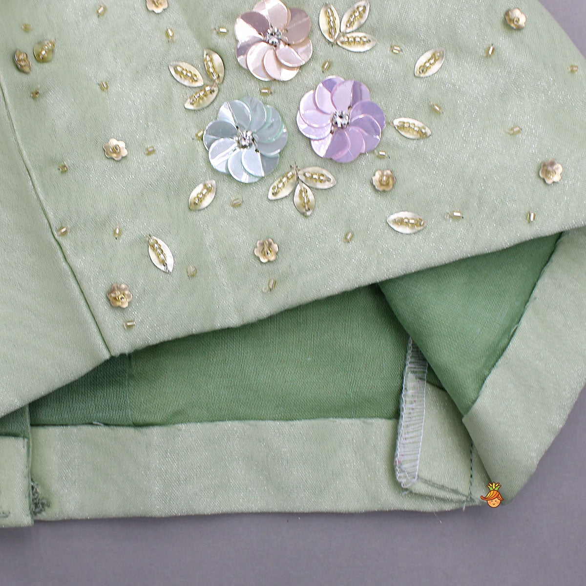 Floral Embroidered Green Sleeveless Top And Fabric Flower Tassels Adorned Lehenga With Ruffle Dupatta