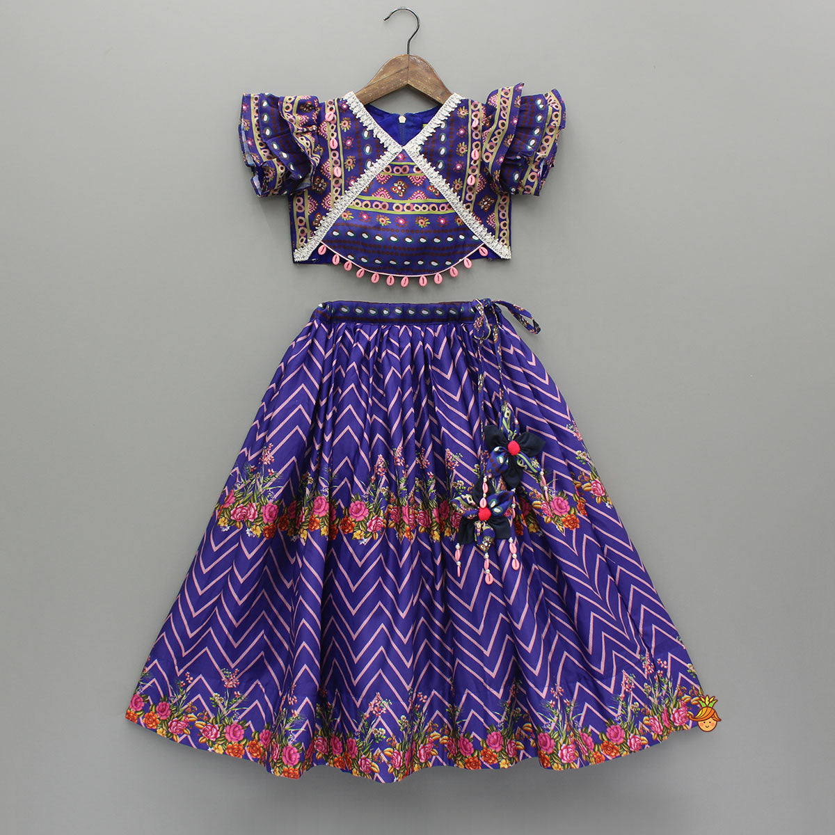 Layered Sleeves Blue Top And Fabric Flower Tassels Enhanced Lehenga With Purple Net Dupatta