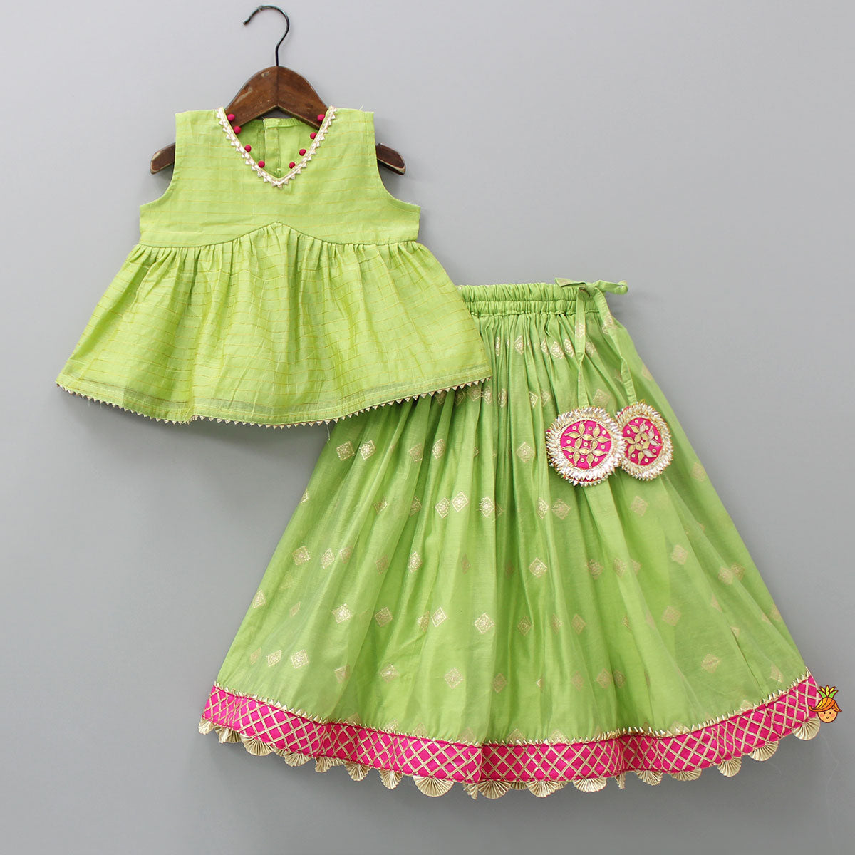 Contrasting Potli Buttons Detail Leaf Green Top And Gota Tassels Enhanced Lehenga