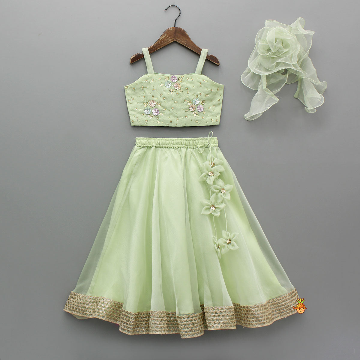 Floral Embroidered Green Sleeveless Top And Fabric Flower Tassels Adorned Lehenga With Ruffle Dupatta
