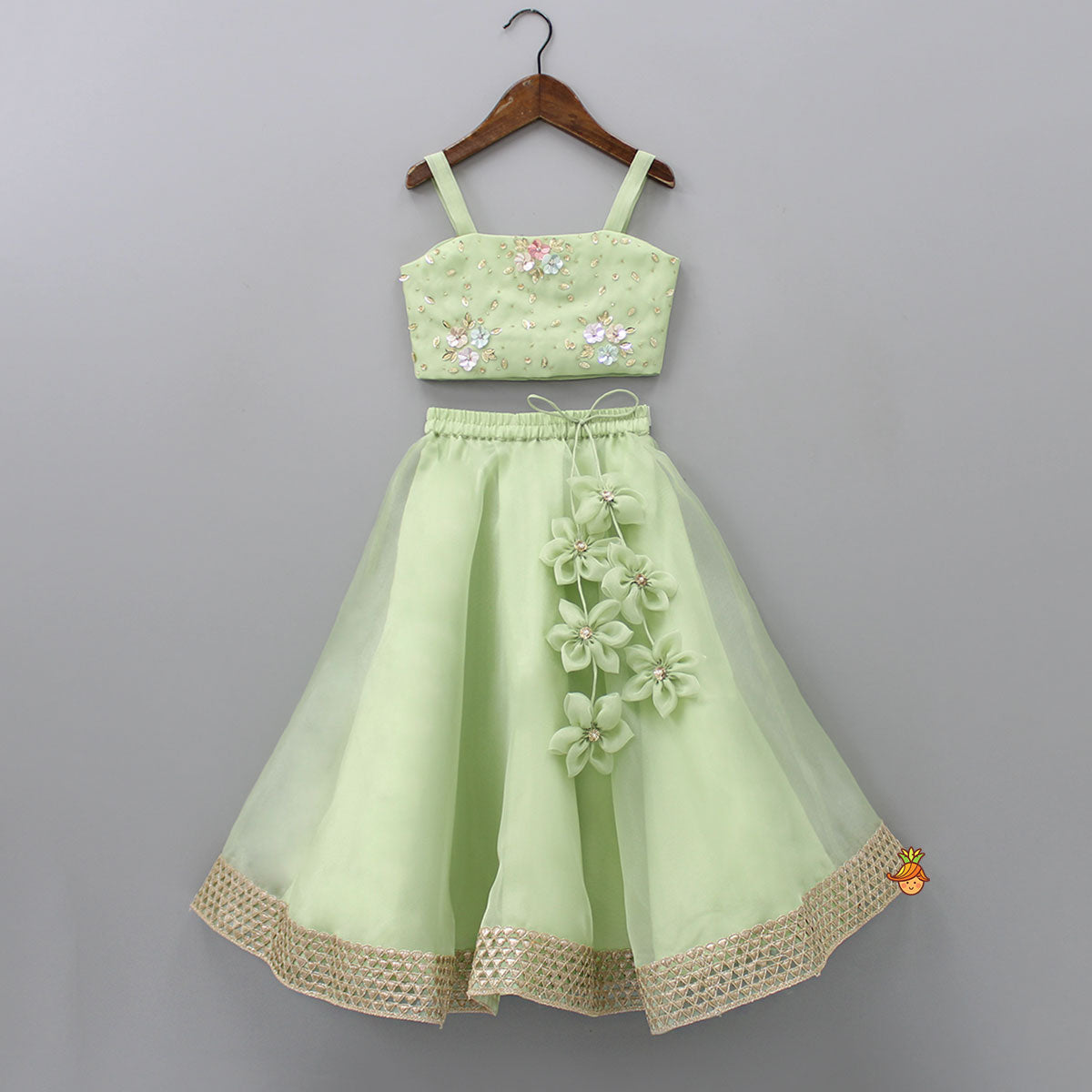 Floral Embroidered Green Sleeveless Top And Fabric Flower Tassels Adorned Lehenga With Ruffle Dupatta