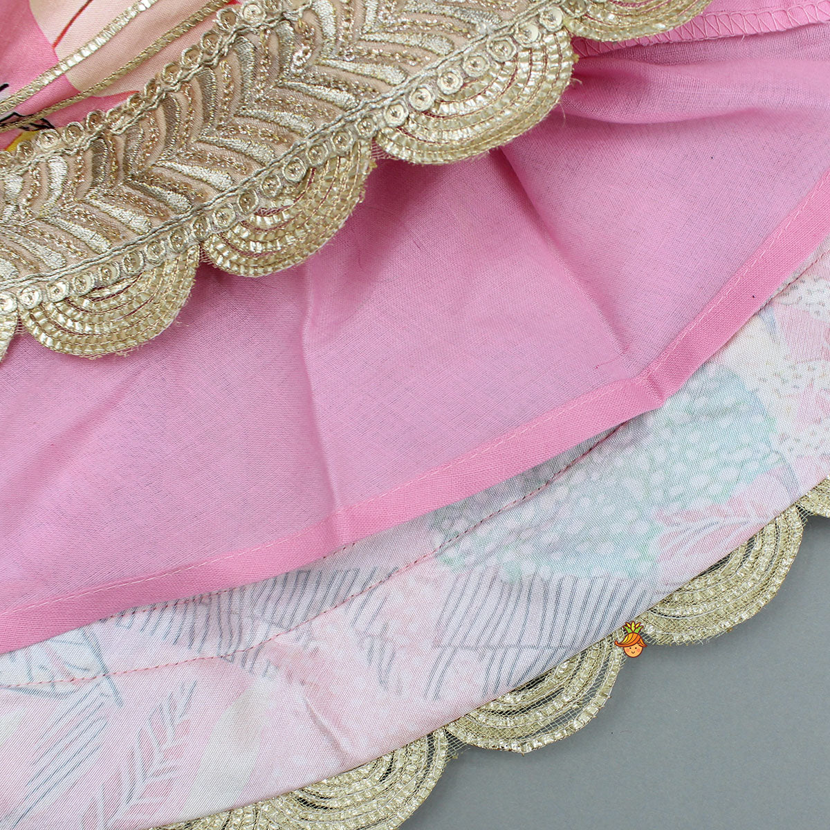 Buttons Adorned Pink Top And Scalloped Lace Work Floral Lehenga