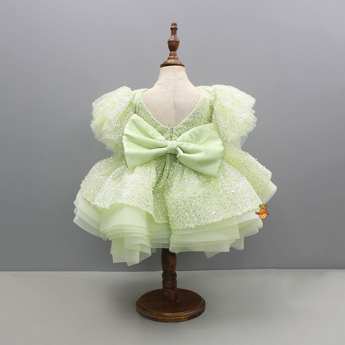 Green Sequin Embellished Dress Featuring Detachable Trail And Bow Paired With Swirled Bow Hairclip