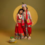 Festive Red Dhoti With Printed Shawl And Mor Pankh-Embellished Headband twinning model image 1