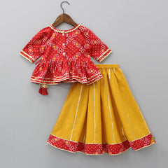 Pre Order: Bandhani Printed Red Angrakha Style Top With Lehenga And Matching Booties With Head Band