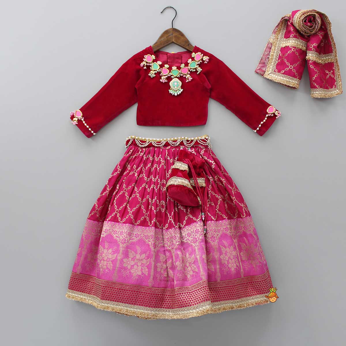 Pre Order: Stone Studded Pink Velvet Top And Embroidered Lehenga With Matching Dupatta And Potli Bag